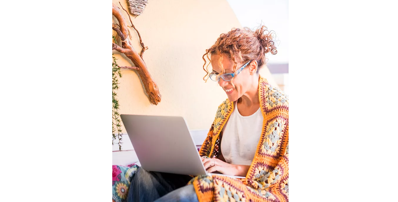 Smiling woman looking at her laptop