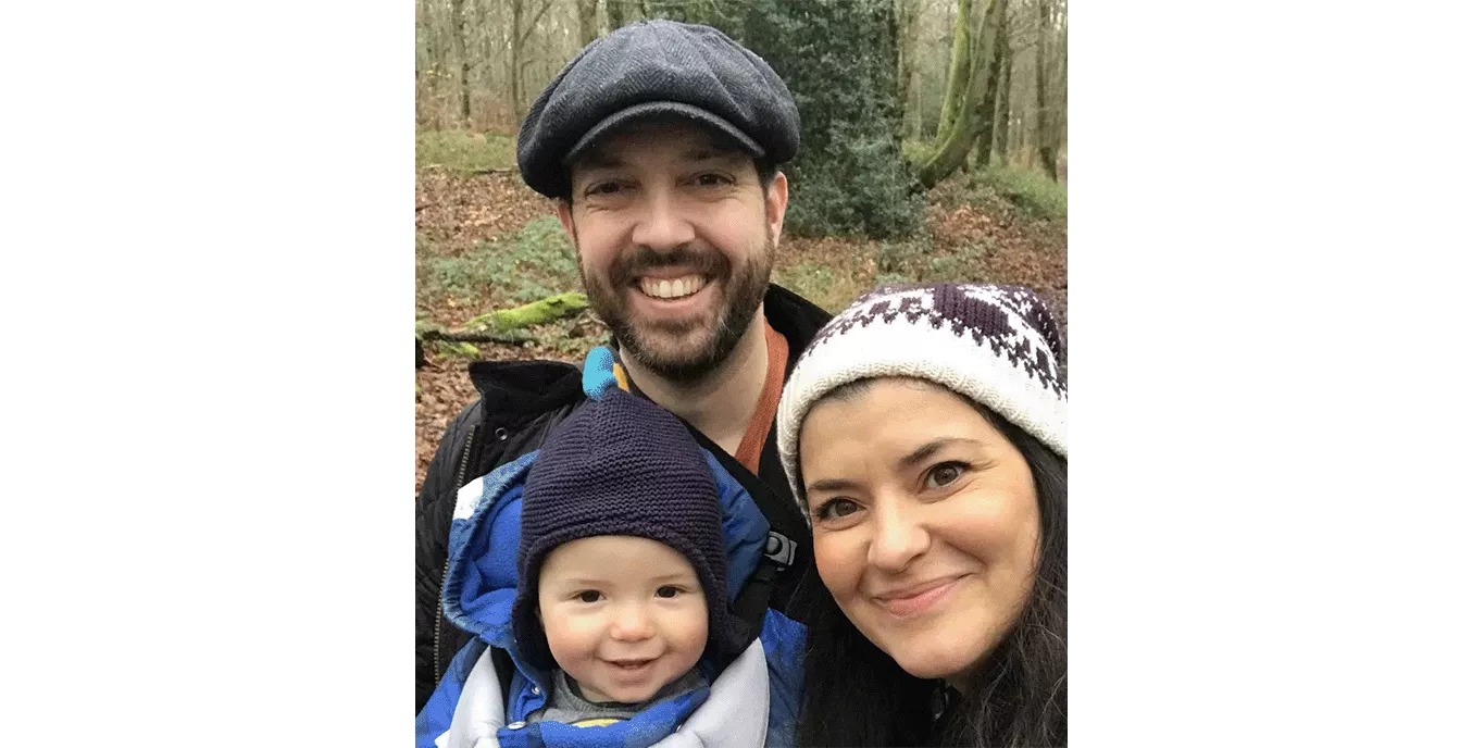 Smiling couple on a walk with their baby