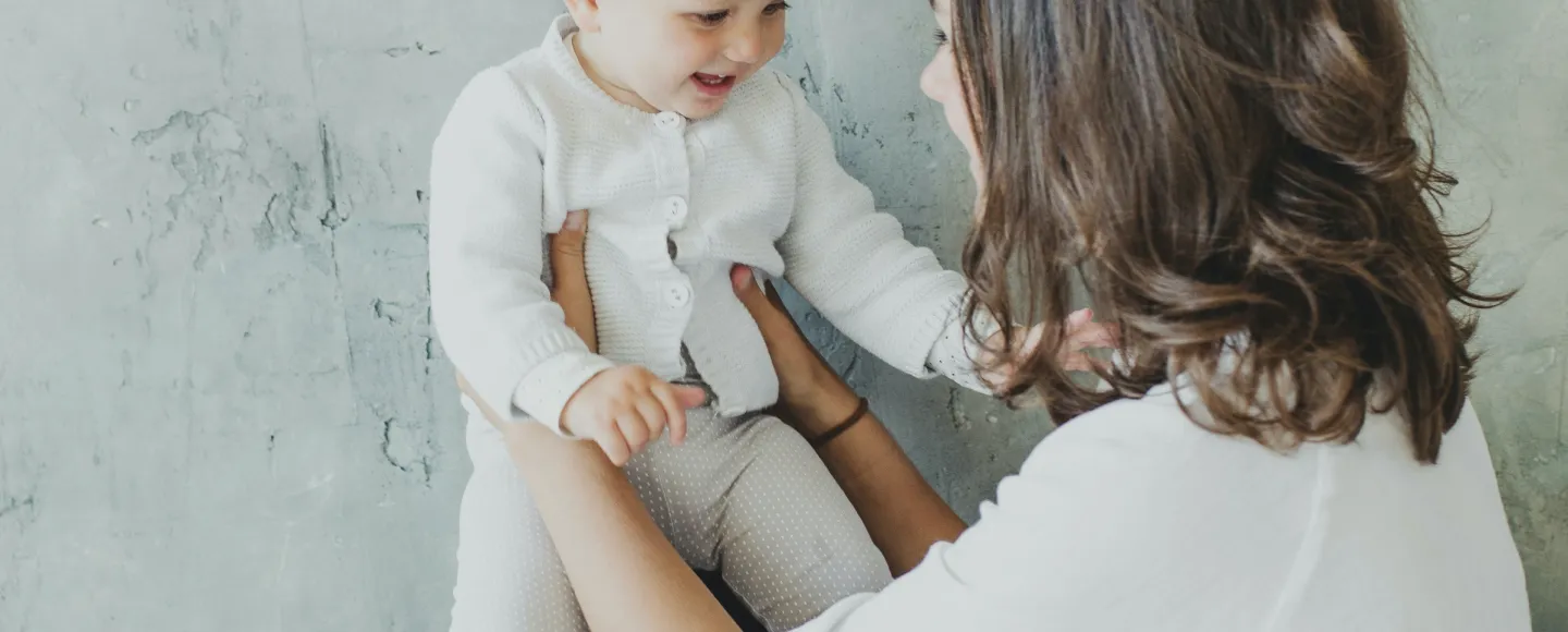 Woman holding happy baby.