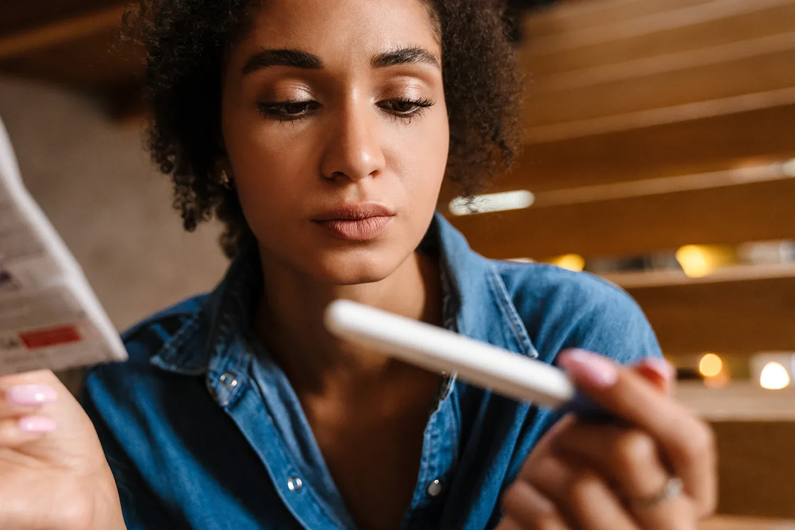woman looks disheartened at a negative pregnancy result
