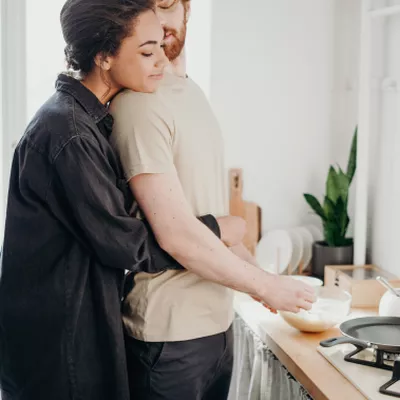 Woman hugging man.